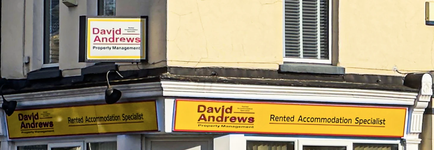 Illustrative reference photo of a horizontal fascia sign mounted above a storefront entrance